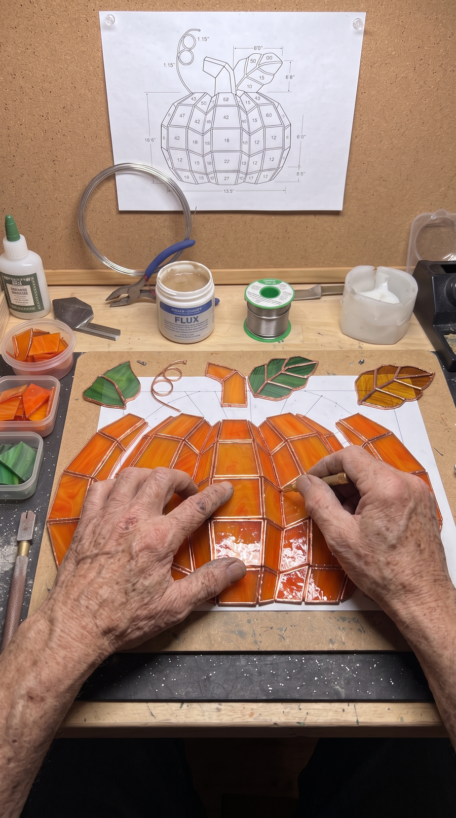 Handcrafted stained glass pumpkin lamp being made
