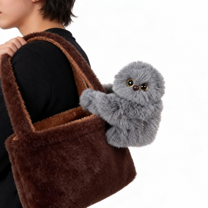 Grey Peeko Bag Buddy on a brown shoulder bag